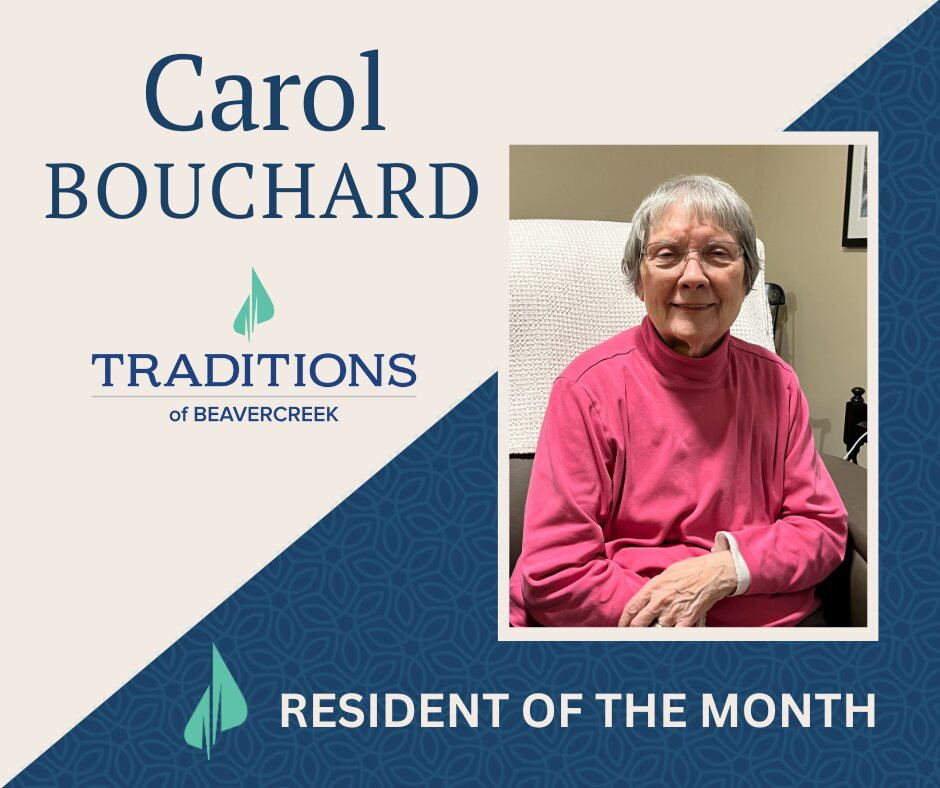 a smiling elderly woman in a pink turtleneck with text overlay "Carol Bouchard Traditions of Beavercreek Resident of the Month"