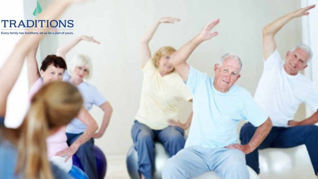 a group of elderly men and women each sitting on an exercise ball while doing upper body stretches